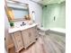 Stylish bathroom featuring modern vanity, mirror, lighting, and glass-enclosed shower at 3529 Tanglewood Trl, Palm Harbor, FL 34685