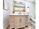 Stylish bathroom featuring modern vanity, mirror, lighting, and toilet at 3529 Tanglewood Trl, Palm Harbor, FL 34685