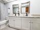 Bathroom featuring double sinks, granite countertop, modern fixtures, and decorative mirrors at 3529 Tanglewood Trl, Palm Harbor, FL 34685