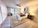 Well lit bedroom featuring a ceiling fan, comfortable decor and a view of the outside at 3529 Tanglewood Trl, Palm Harbor, FL 34685