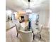 Dining room featuring a modern chandelier and open access to living spaces at 3529 Tanglewood Trl, Palm Harbor, FL 34685