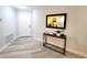 Modern entryway with sleek table, contemporary mirror, and wood-look flooring at 3529 Tanglewood Trl, Palm Harbor, FL 34685