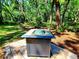 Outdoor fire pit with a modern design, set on a brick base, perfect for gatherings at 3529 Tanglewood Trl, Palm Harbor, FL 34685