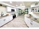 Updated kitchen with stainless appliances, granite counters and modern cabinetry and barn doors to the dining room at 3529 Tanglewood Trl, Palm Harbor, FL 34685