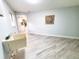 Spacious laundry room with utility sink and modern flooring; view into Kitchen at 3529 Tanglewood Trl, Palm Harbor, FL 34685