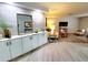 Living room featuring storage cabinets, decorative mirror, and modern decor at 3529 Tanglewood Trl, Palm Harbor, FL 34685