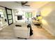 Bright living room featuring stone fireplace, modern furnishings, ceiling fan, and view to outside at 3529 Tanglewood Trl, Palm Harbor, FL 34685