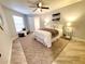 Spacious main bedroom featuring modern decor, ceiling fan, and a walk-in closet at 3529 Tanglewood Trl, Palm Harbor, FL 34685