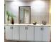 Custom storage with decorative tile backsplash, marble countertops, and accent lighting at 3529 Tanglewood Trl, Palm Harbor, FL 34685