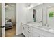 Bright bathroom featuring marble counters, double vanity and access to bedroom at 3905 W San Obispo St, Tampa, FL 33629