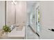Bathroom with modern vanity, neutral walls and open door to outdoor living area with pool at 3905 W San Obispo St, Tampa, FL 33629