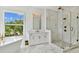 Bright bathroom featuring marble floors, modern double vanity, soaking tub and glass enclosed shower at 3905 W San Obispo St, Tampa, FL 33629