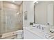 Neutral bathroom featuring a glass shower, modern vanity and fixtures, and neutral tile at 3905 W San Obispo St, Tampa, FL 33629