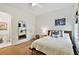 Bedroom features hardwood floors, neutral decor and view into attached bathroom at 3905 W San Obispo St, Tampa, FL 33629