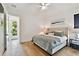 Bright, airy bedroom with hardwood floors, comfortable bed, and access to the outdoors at 3905 W San Obispo St, Tampa, FL 33629