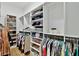 Organized closet featuring hanging clothes, shelves for shoes, handbags and other items at 3905 W San Obispo St, Tampa, FL 33629