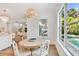 Eat in dining area with rustic-style table and white chairs near kitchen and pool view at 3905 W San Obispo St, Tampa, FL 33629