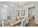 Spacious dining room featuring a modern chandelier, seating for six, and an open floor plan at 3905 W San Obispo St, Tampa, FL 33629