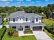 Two-story home featuring a well-manicured front lawn, tasteful landscaping, and elegant facade at 3905 W San Obispo St, Tampa, FL 33629