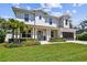 Charming two-story home featuring white siding, a well-manicured lawn, and a spacious two-car garage at 3905 W San Obispo St, Tampa, FL 33629