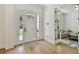 Open foyer with hardwood floors, white trim, and a view into the adjacent living room at 3905 W San Obispo St, Tampa, FL 33629