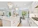 Bright, white kitchen with a farmhouse sink, marble countertops, and modern chandeliers at 3905 W San Obispo St, Tampa, FL 33629