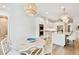 Bright open concept kitchen with white cabinetry and eat-in breakfast nook with bamboo chandelier at 3905 W San Obispo St, Tampa, FL 33629