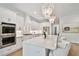 Bright kitchen featuring white cabinetry, stainless appliances, and a center island with seating at 3905 W San Obispo St, Tampa, FL 33629