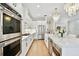 Elegant kitchen with stainless steel appliances, marble countertops, and chandelier at 3905 W San Obispo St, Tampa, FL 33629