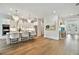 Open-concept kitchen and living area with hardwood floors and stylish lighting at 3905 W San Obispo St, Tampa, FL 33629