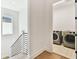 A second-floor laundry room offers tile floors, side-by-side washer, and dryer at 3905 W San Obispo St, Tampa, FL 33629