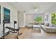 Bright, open living area featuring a comfortable sectional, hardwood floors, and ample natural light at 3905 W San Obispo St, Tampa, FL 33629