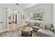 Bright living room featuring a comfortable sofa, stylish rug, and open access to the dining area at 3905 W San Obispo St, Tampa, FL 33629