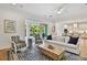 Open-concept living room showcasing the kitchen, with sliding doors leading to the outdoor pool area at 3905 W San Obispo St, Tampa, FL 33629
