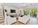 Cozy living room features shiplap wall, entertainment center, and sliding doors to the outdoor pool at 3905 W San Obispo St, Tampa, FL 33629