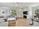 Bright living area with comfortable sectional sofa, TV, hardwood flooring, and window views at 3905 W San Obispo St, Tampa, FL 33629
