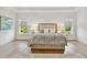 A bright main bedroom showcases hardwood floors, a large window, and soft decor at 3905 W San Obispo St, Tampa, FL 33629