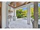 Covered outdoor kitchen boasts a stainless steel grill, lush landscaping, and a view of the pool at 3905 W San Obispo St, Tampa, FL 33629