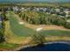 Expansive aerial view of the golf course and surrounding community, with lush green fairways and tree coverage at 40 Pine Lake Dr, Oldsmar, FL 34677