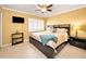 Bedroom with ample natural light featuring a ceiling fan and simple bedside furniture at 40 Pine Lake Dr, Oldsmar, FL 34677