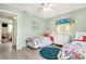 Bedroom featuring two twin beds with patterned comforters, dresser, and coastal wall art at 412 80Th St, Holmes Beach, FL 34217