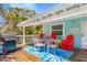 Outdoor dining set and grill on a spacious deck, perfect for beachside entertaining and relaxing at 412 80Th St, Holmes Beach, FL 34217