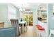 Bright dining room features a view to the deck, seating for six, and a connection to the kitchen at 412 80Th St, Holmes Beach, FL 34217