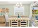 Lovely dining area with a beachy aesthetic, seating for four, and a bright chandelier at 412 80Th St, Holmes Beach, FL 34217
