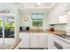 Bright kitchen with granite countertops and modern appliances, leading to an outdoor living area at 412 80Th St, Holmes Beach, FL 34217