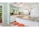 Well-lit kitchen with a granite countertop island, white cabinetry, and modern appliances at 412 80Th St, Holmes Beach, FL 34217