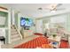 Charming living room with stairs, a mounted TV, beach decor, and comfortable seating at 412 80Th St, Holmes Beach, FL 34217