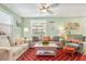 Inviting living room featuring comfortable seating, a ceiling fan, and coastal decor accents at 412 80Th St, Holmes Beach, FL 34217