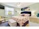 Serene main bedroom featuring a comfortable bed, beach-themed decor, and lots of natural light at 412 80Th St, Holmes Beach, FL 34217