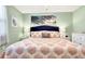 Serene main bedroom with a plush bed, beach-themed decor, and a calm atmosphere at 412 80Th St, Holmes Beach, FL 34217